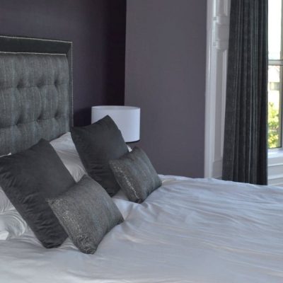 Headboard in Today Interior's Basalt fabric and bordered in Blendworth velvet with chrome studs & buttons